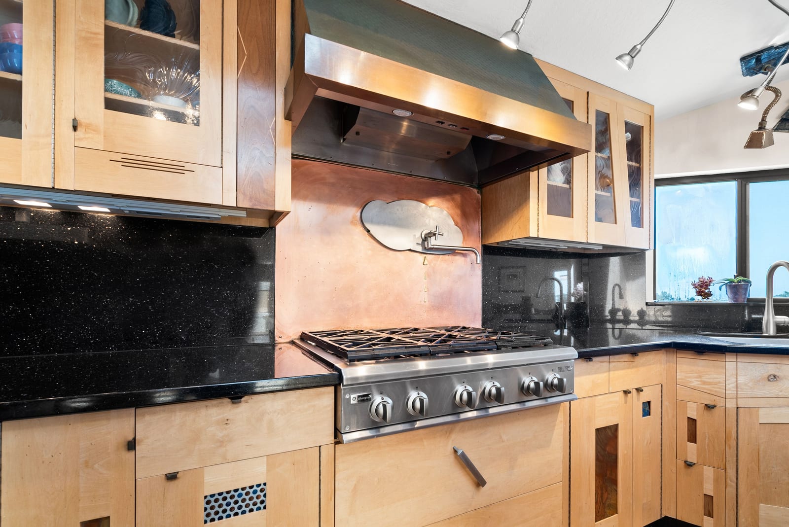 Six-burner gas range with copper backsplash and pot filler