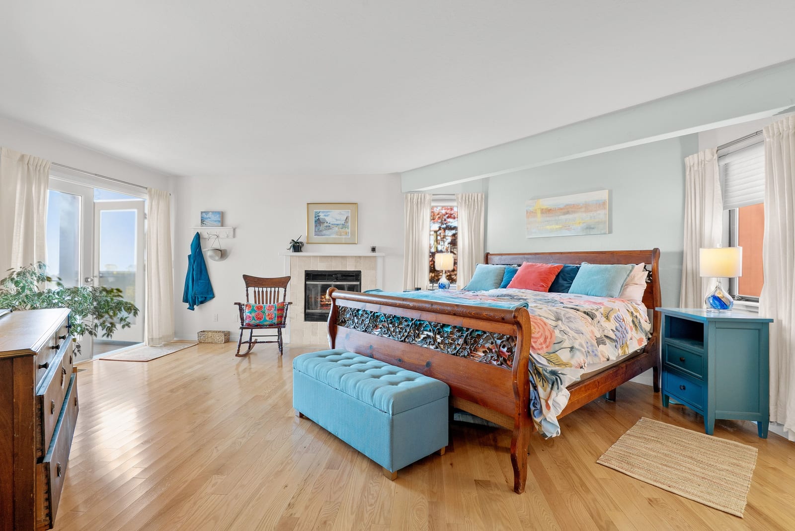 Primary bedroom with hardwood floors and bright windows